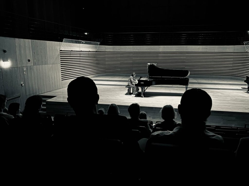 a person playing a piano on a stage