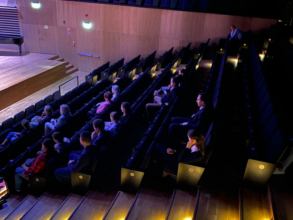 a group of people sitting in a auditorium