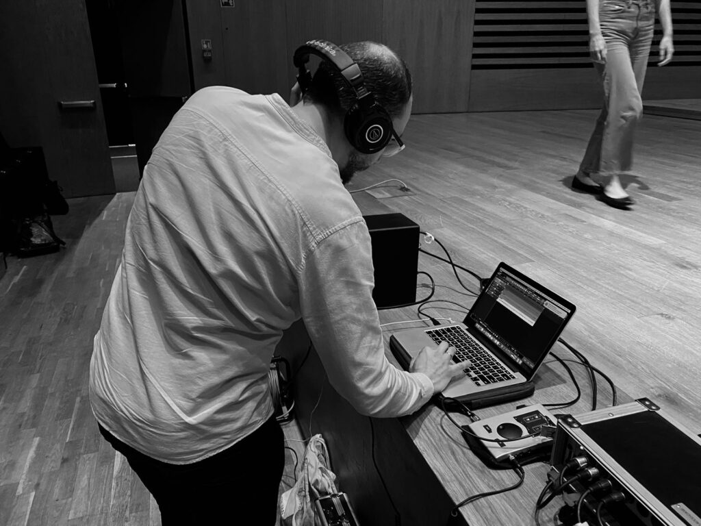 a man wearing headphones and using a laptop