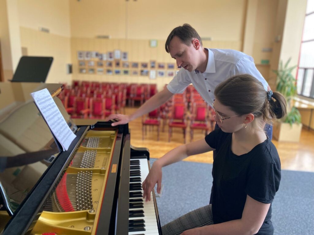 a man and woman playing piano