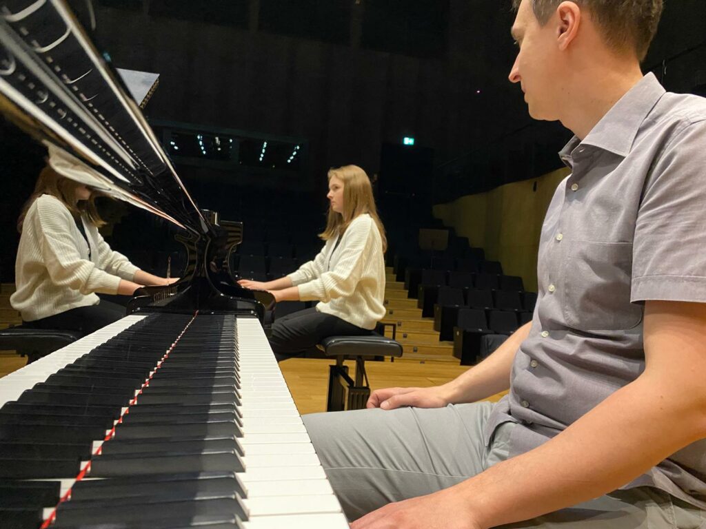 a man and woman playing piano