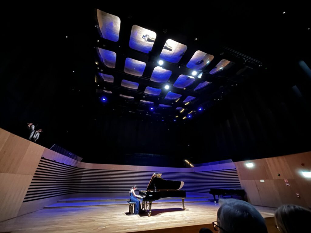 a person playing a piano on a stage