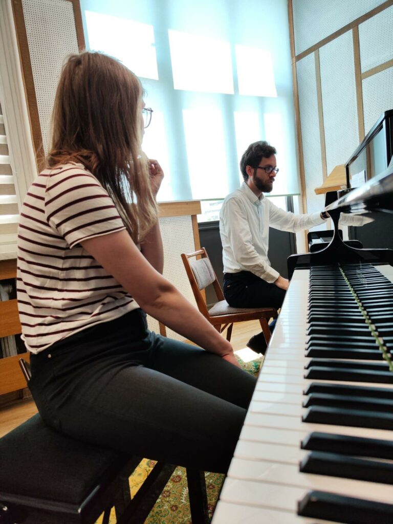 a man and woman playing piano